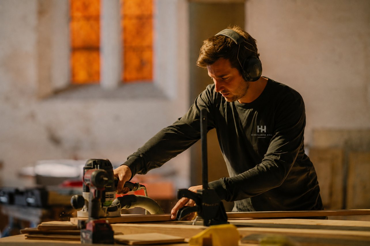 Herringbone Hill craftsman shaping timber flooring